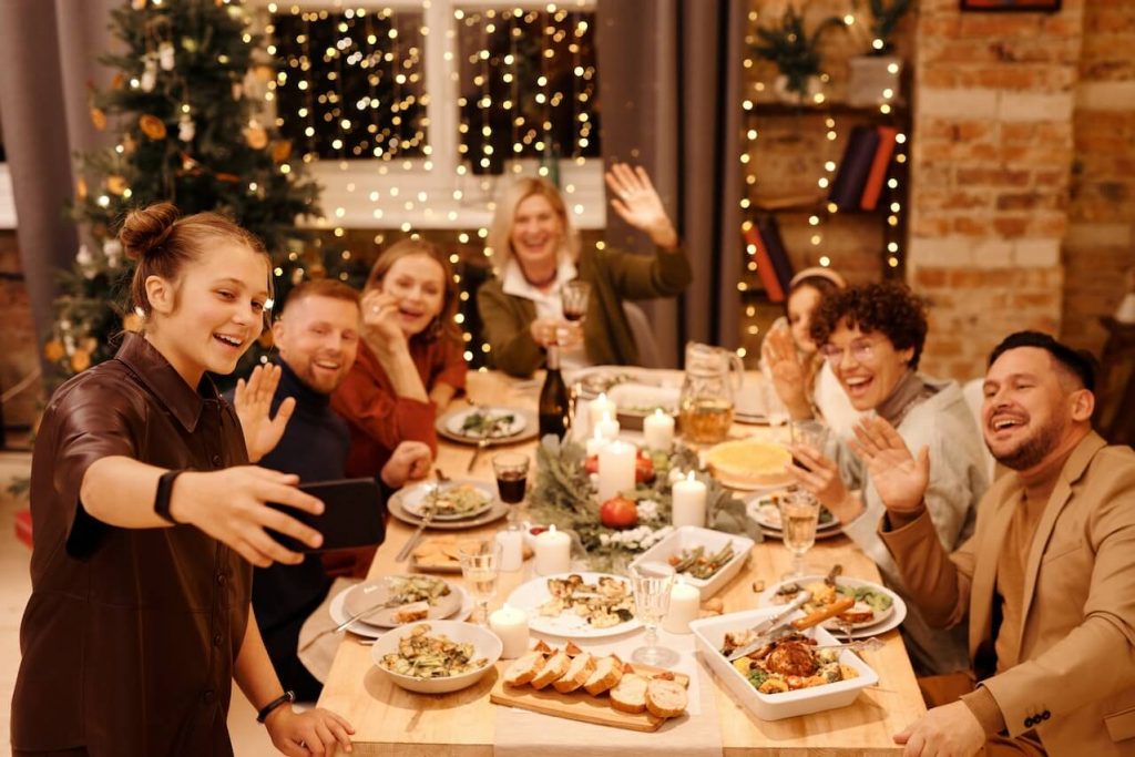 A group of friends gather around the table at a budget-friendly holiday party