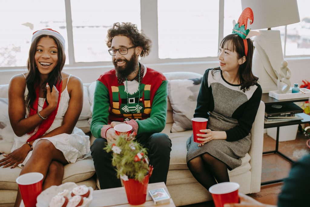 Three employees enjoy a murder mystery holiday party as their employee gift