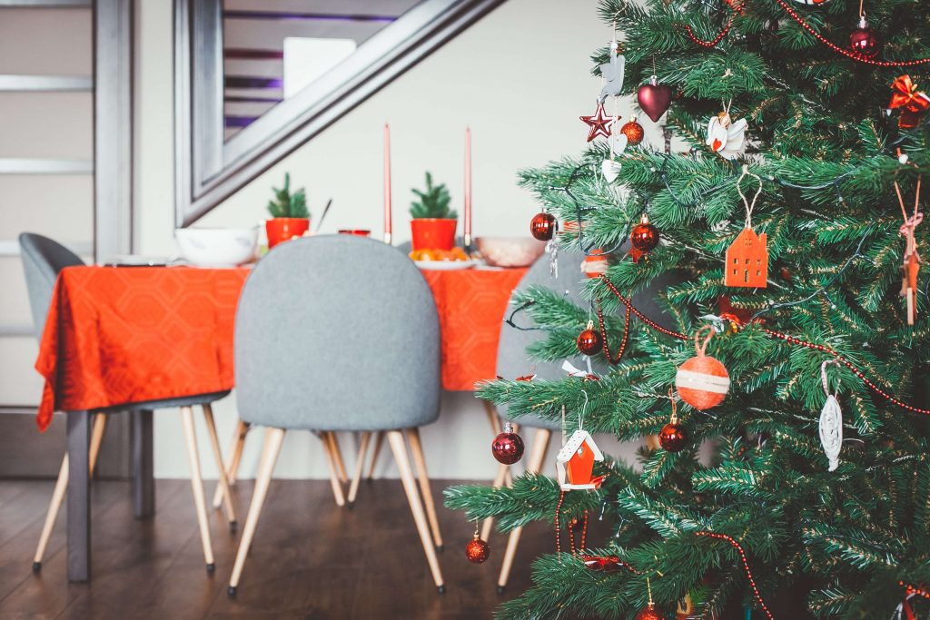 A festive table is pictured behind a Christmas tree