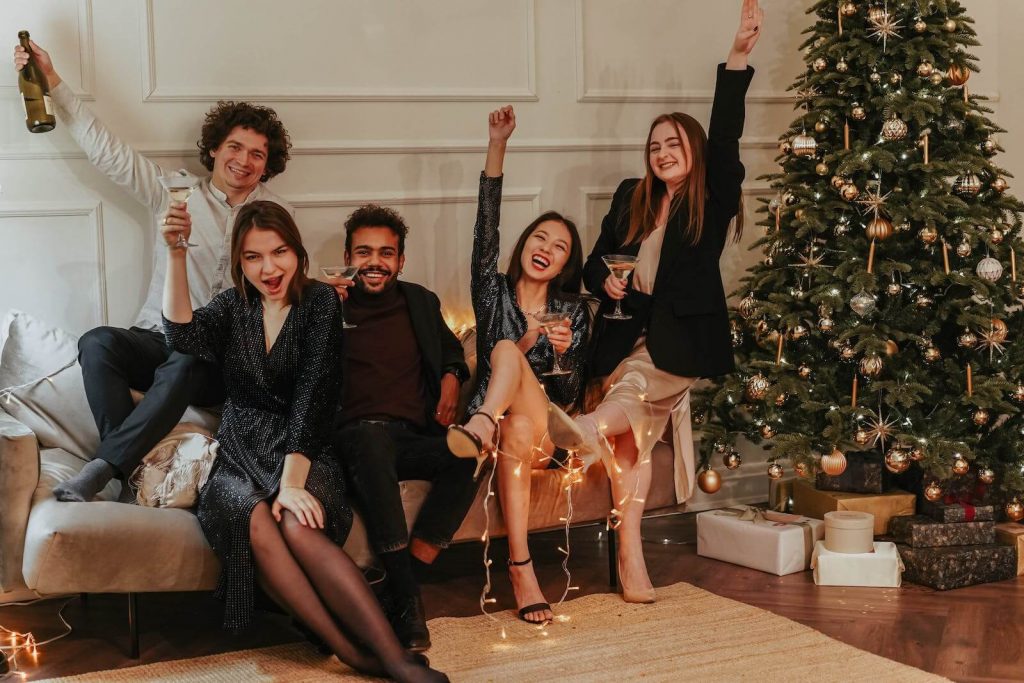 A group of friends raises a toast at a Friendsmas holiday celebration