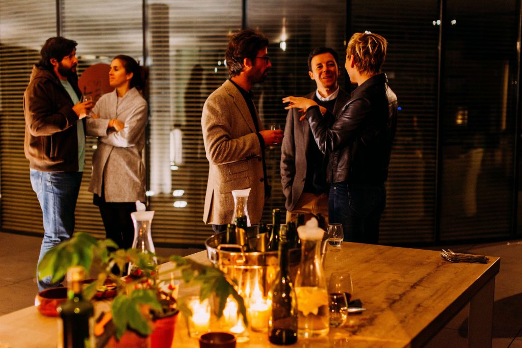 A group of adults socialize at a holiday party